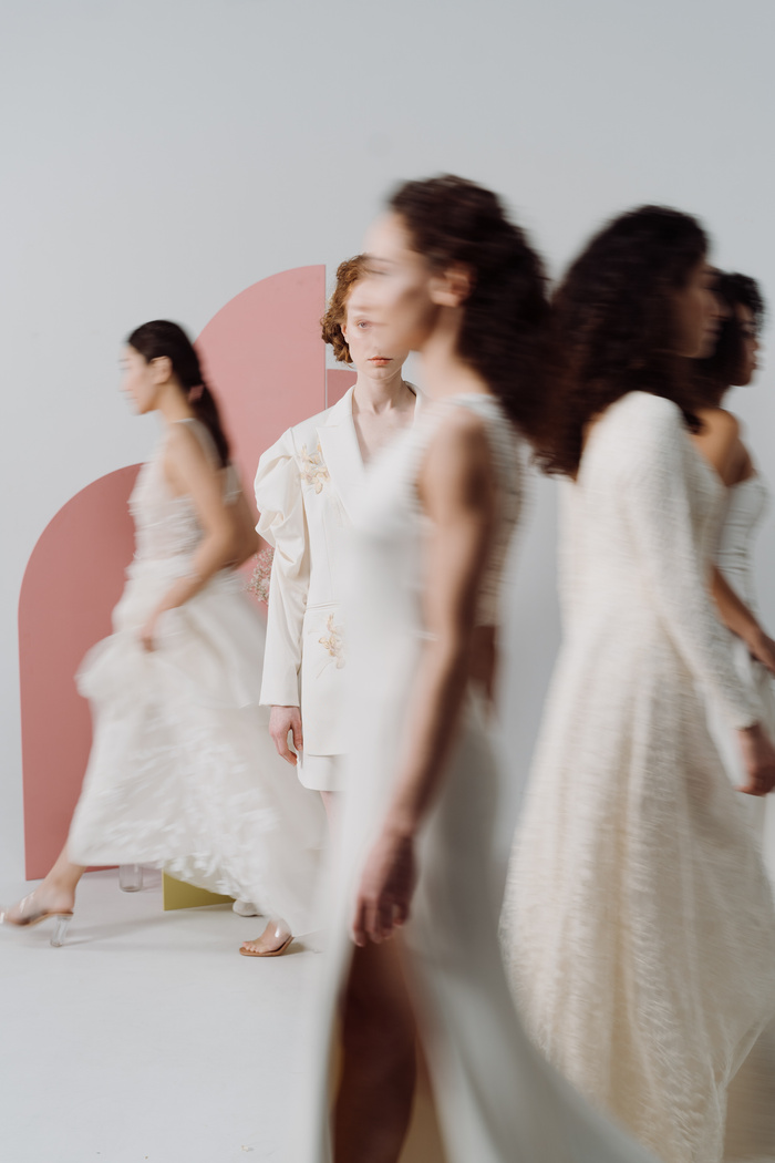 A Group of Women in White Dresses Walking